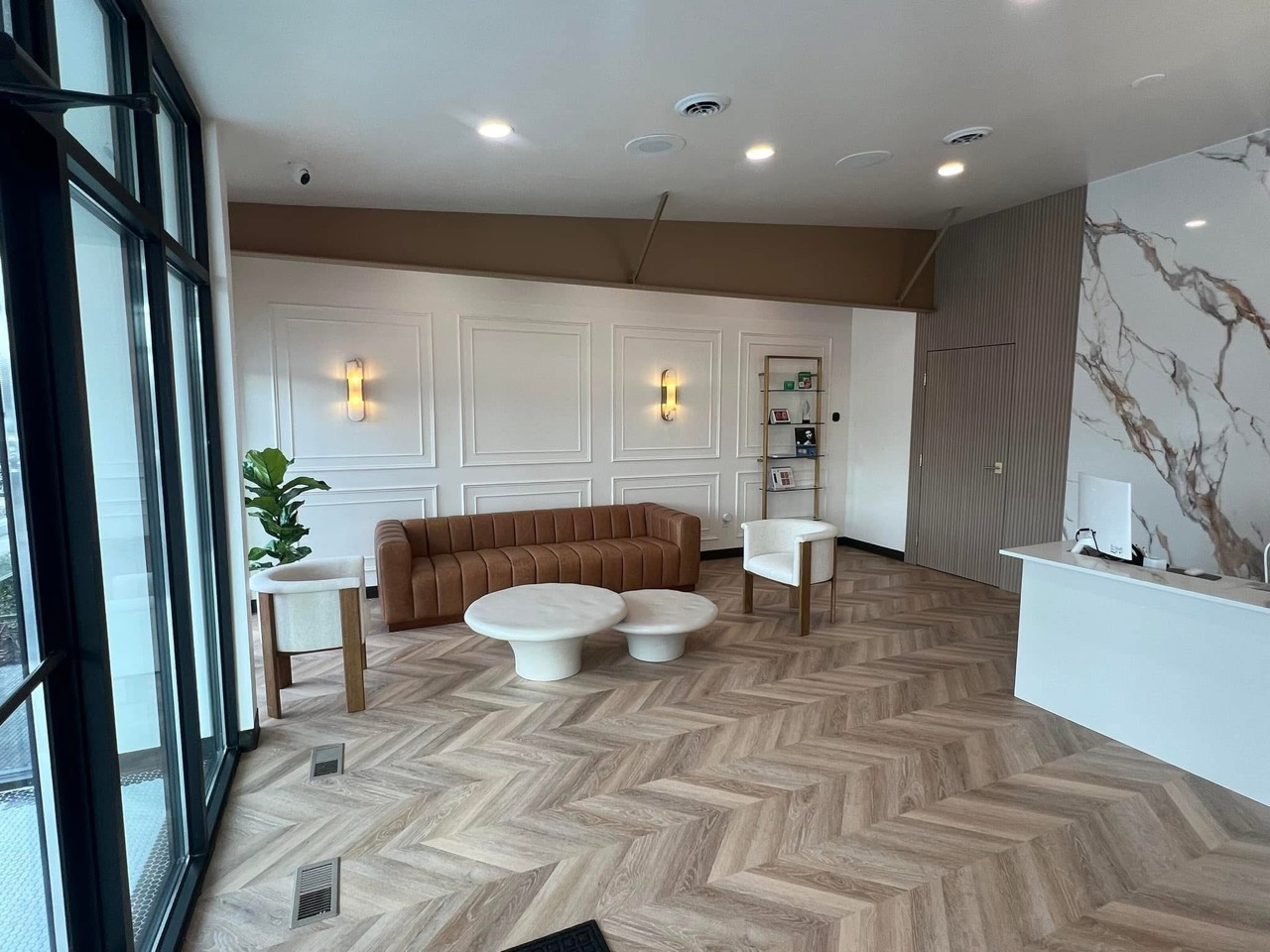 Completed DHR commercial reception with custom millwork and herringbone flooring