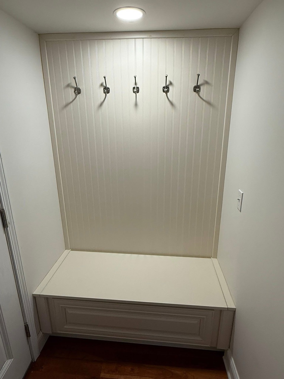 Built-in mudroom bench with beadboard and hooks by DHR